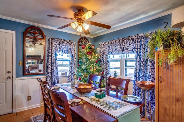 tiled dining area featuring crown molding and ceiling fan