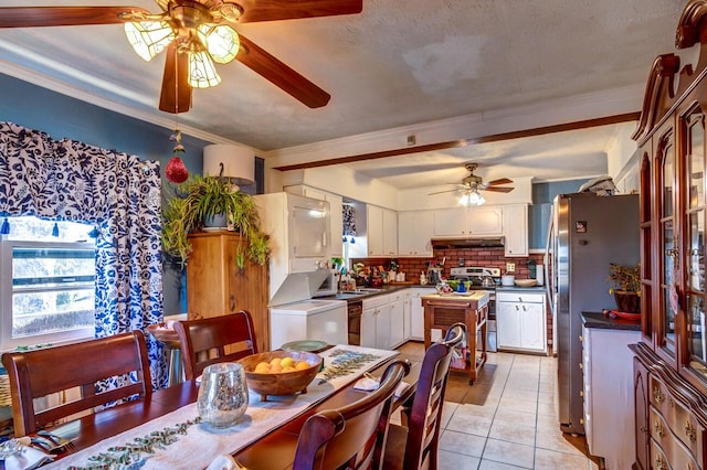 tiled dining area with ceiling fan, ornamental molding, and a textured ceiling