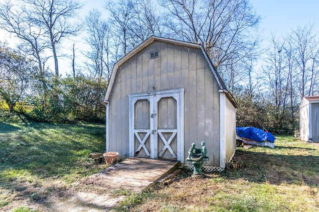 view of outdoor structure featuring a lawn