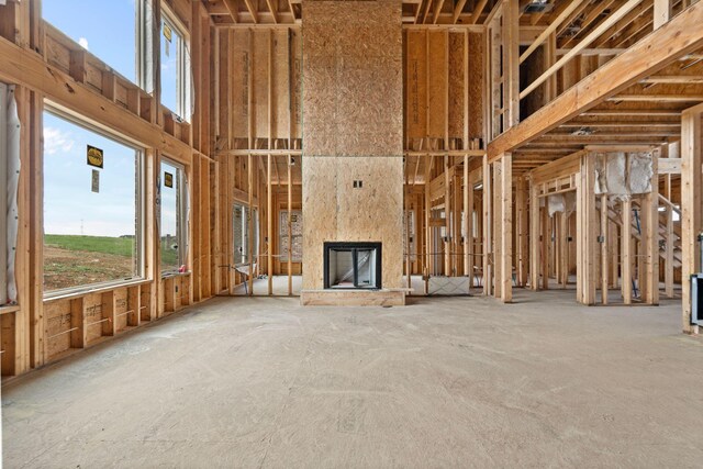 unfurnished living room with an outdoor stone fireplace