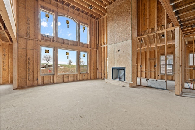 interior space with a large fireplace and a high ceiling