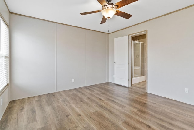 spare room featuring ceiling fan, light wood-type flooring, and a wealth of natural light