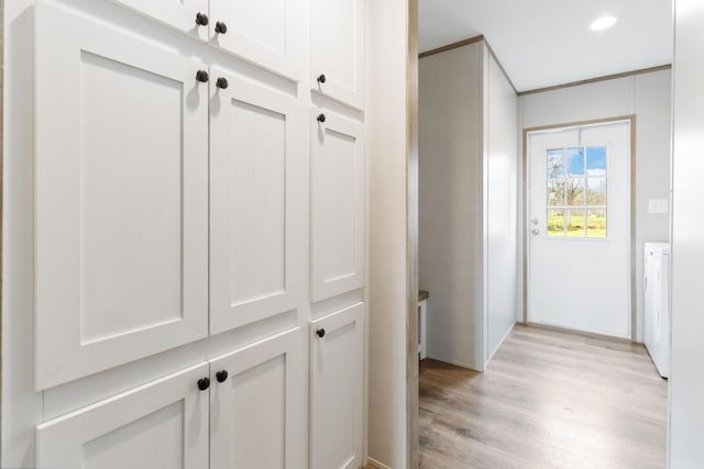 hall featuring washer / clothes dryer and light wood-type flooring