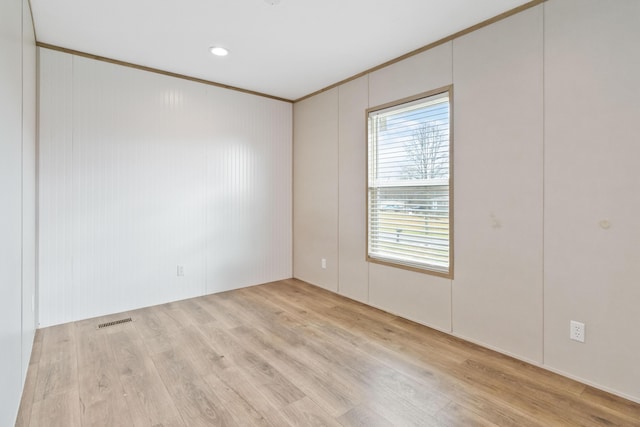 unfurnished room featuring crown molding and light hardwood / wood-style flooring