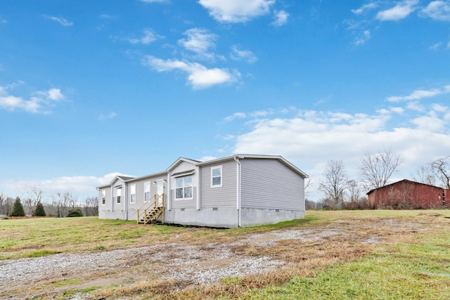 view of side of property with a lawn