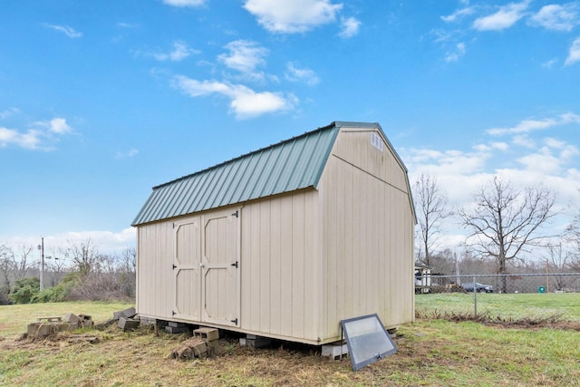 view of outdoor structure featuring a lawn