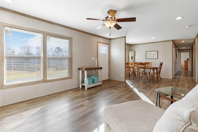 living room featuring crown molding, ceiling fan, and hardwood / wood-style flooring