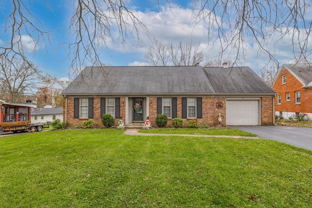 view of front of home with a garage and a front lawn