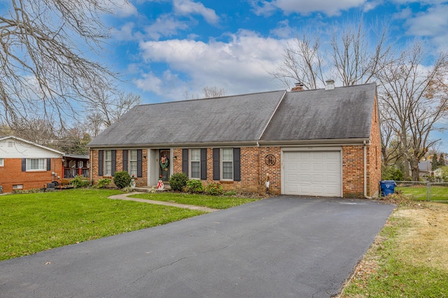 view of front of property featuring a garage and a front lawn