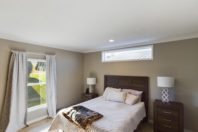 bedroom with light wood-type flooring and ornamental molding