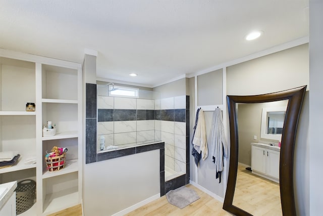 bathroom with a shower, wood-type flooring, and vanity