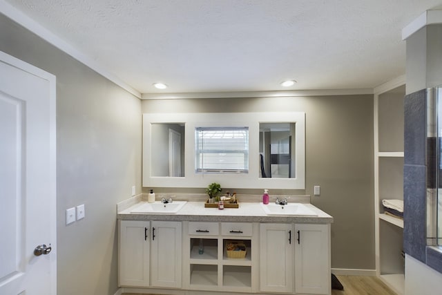 bathroom with vanity, wood-type flooring, and a textured ceiling