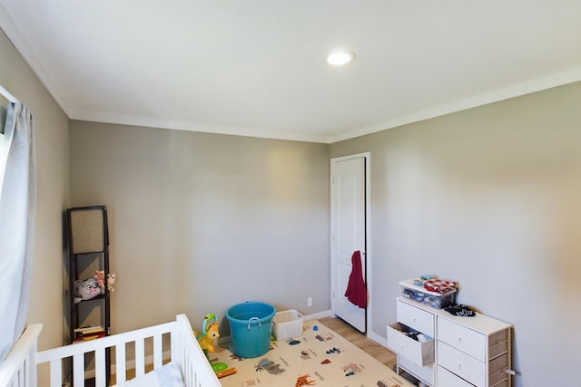 bedroom featuring light wood-type flooring and ornamental molding