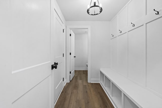 mudroom with dark hardwood / wood-style floors and a chandelier