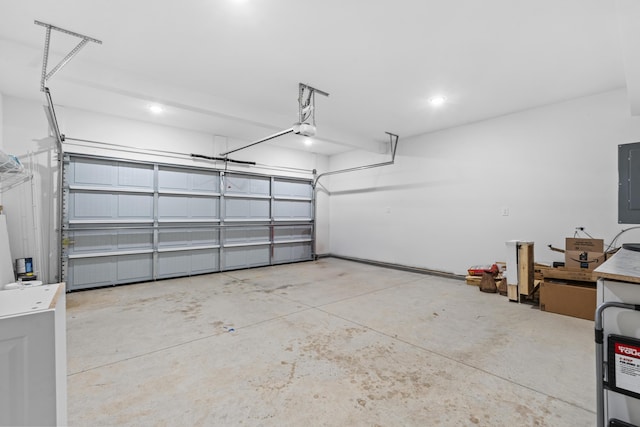 garage featuring electric panel and a garage door opener