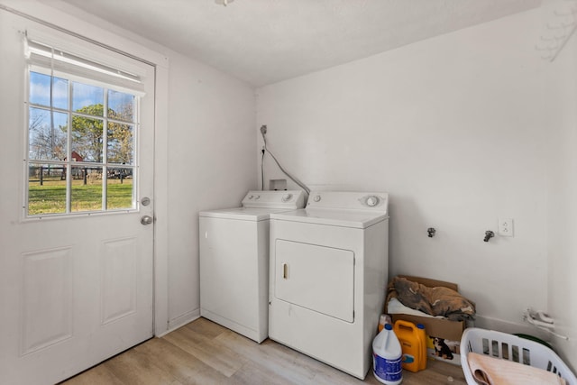 washroom with washer and dryer and light wood-type flooring