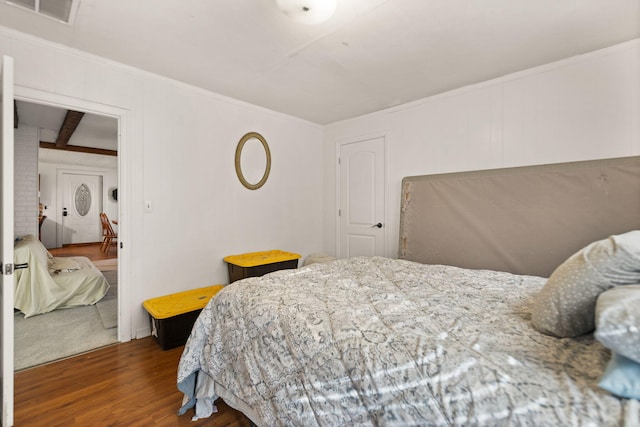 bedroom featuring dark hardwood / wood-style floors and ornamental molding