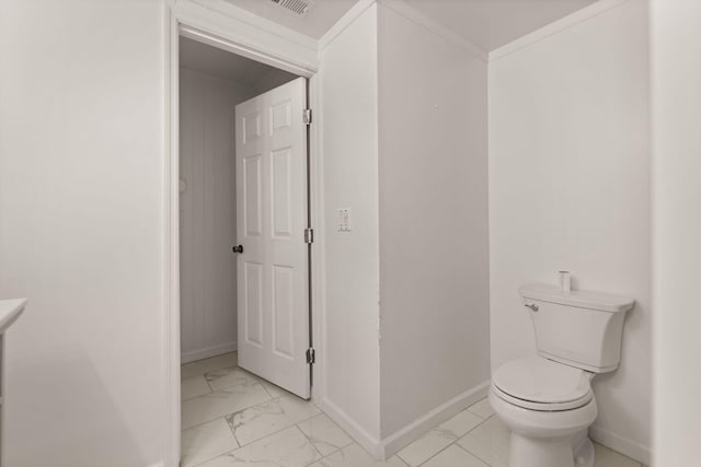 bathroom with toilet and crown molding