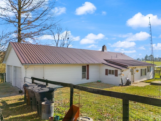 view of side of property featuring a yard and a garage