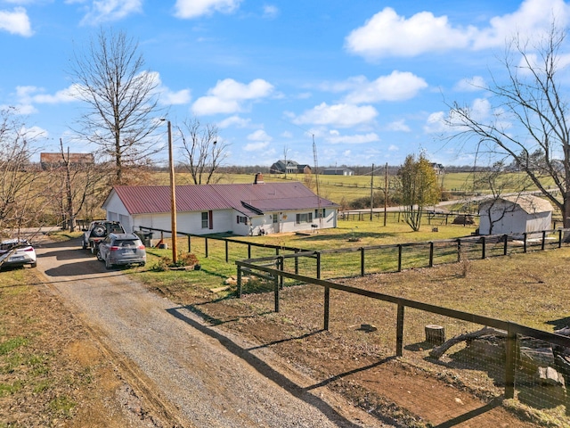 view of front of home featuring a front lawn and a rural view