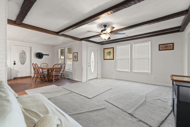 foyer entrance featuring beam ceiling, ceiling fan, and hardwood / wood-style floors