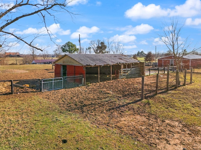 view of horse barn with a rural view