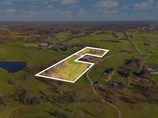 drone / aerial view with a water view and a rural view