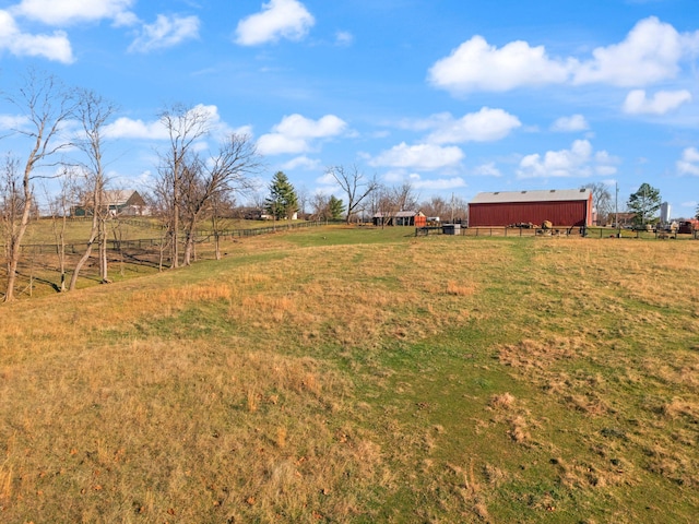 view of yard with a rural view and an outdoor structure