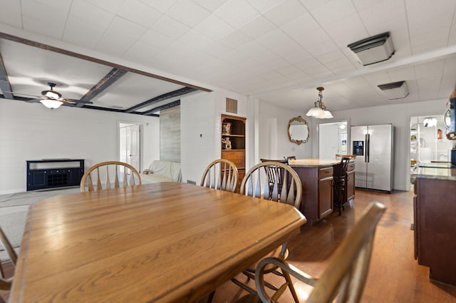 dining room with ceiling fan and dark hardwood / wood-style floors