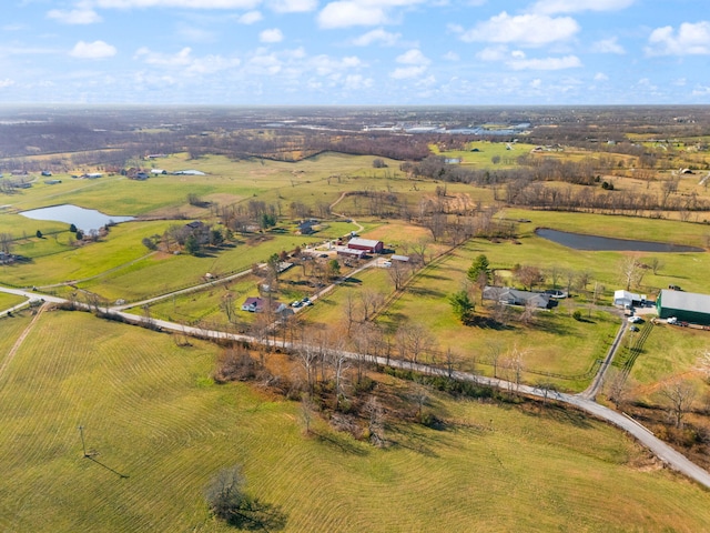 birds eye view of property featuring a rural view and a water view