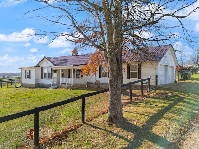 single story home featuring a porch, a garage, and a front yard