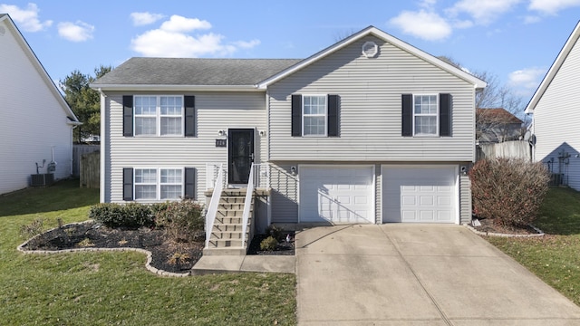 split foyer home with a garage, a front yard, and central AC