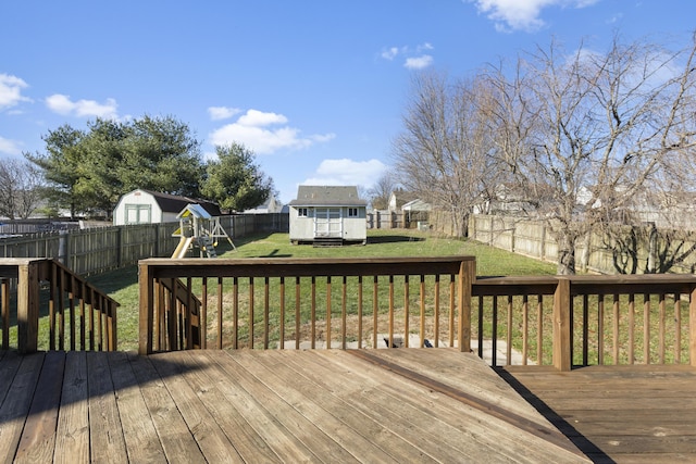 wooden deck with a yard and a playground