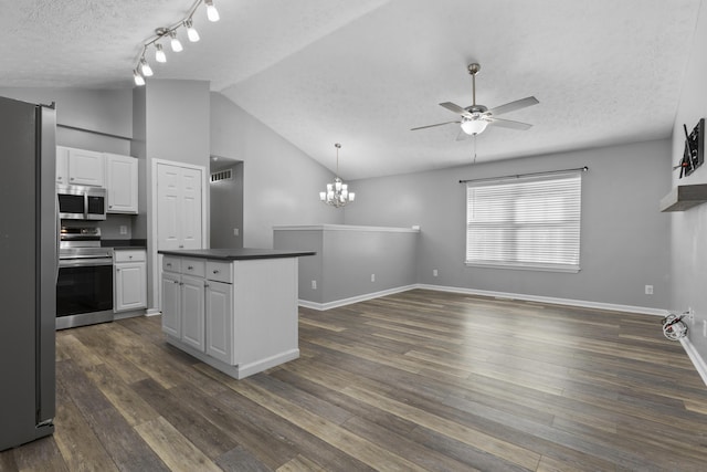 kitchen with a textured ceiling, white cabinetry, dark wood-type flooring, and appliances with stainless steel finishes