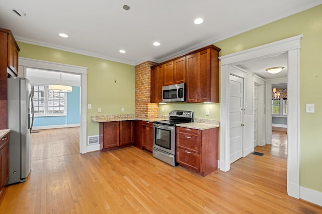 kitchen featuring light stone counters, light wood-type flooring, ornamental molding, and appliances with stainless steel finishes