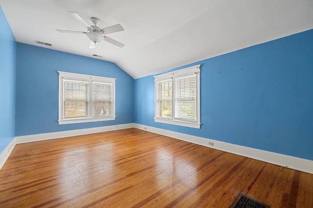 spare room featuring vaulted ceiling, hardwood / wood-style floors, and ceiling fan