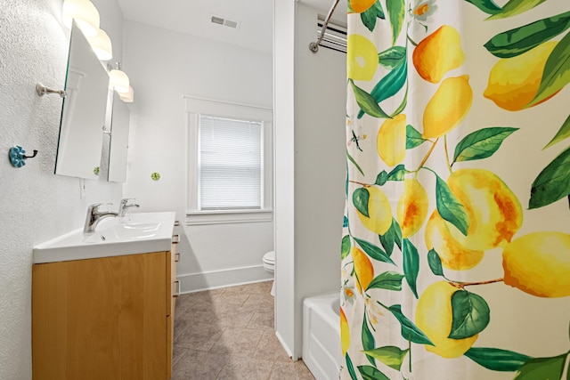 full bathroom featuring vanity, tile patterned flooring, shower / bath combo, and toilet