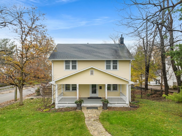 view of front of home with a front yard and covered porch