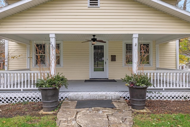 doorway to property with ceiling fan and a porch