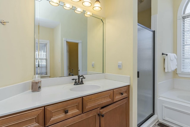 bathroom featuring separate shower and tub and vanity