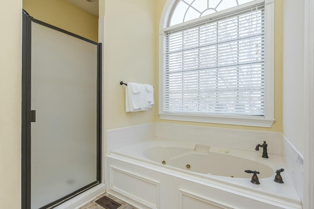 bathroom with plenty of natural light and independent shower and bath