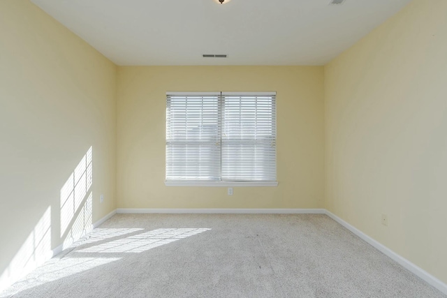 unfurnished room featuring light colored carpet