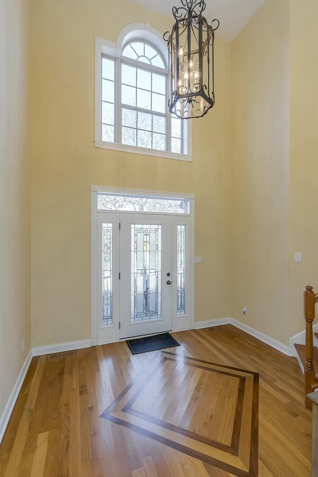 entrance foyer featuring light hardwood / wood-style floors and an inviting chandelier