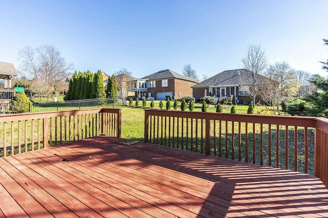 wooden terrace featuring a lawn