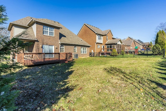 back of property with a yard and a deck