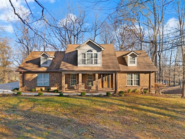 new england style home featuring a front yard