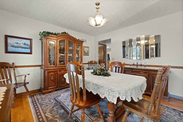 dining room featuring light hardwood / wood-style flooring and an inviting chandelier