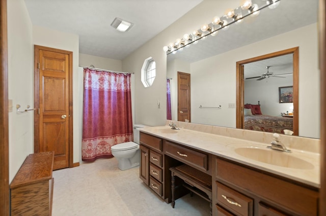 bathroom featuring ceiling fan, toilet, and vanity