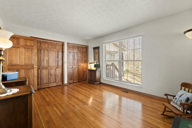 unfurnished office with a textured ceiling and hardwood / wood-style flooring