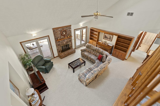 carpeted living room featuring ceiling fan, high vaulted ceiling, and a brick fireplace